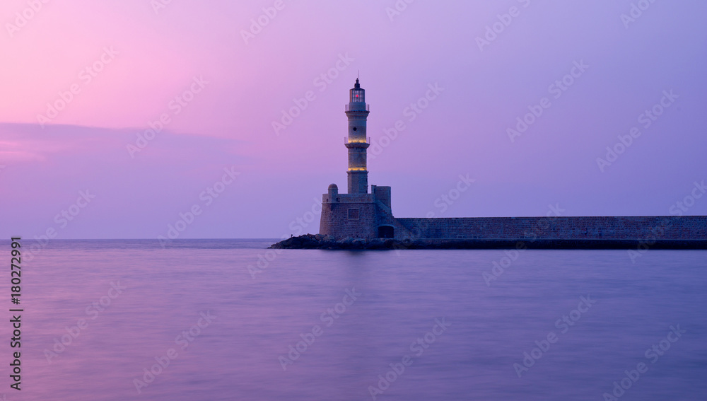 amazing violet sunset with lighthouse in city of Chania