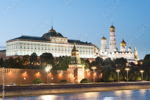 The bell tower of Ivan the Great and the Annunciation Cathedral in the Moscow Kremlin. Grand palace and brick red wall with towers