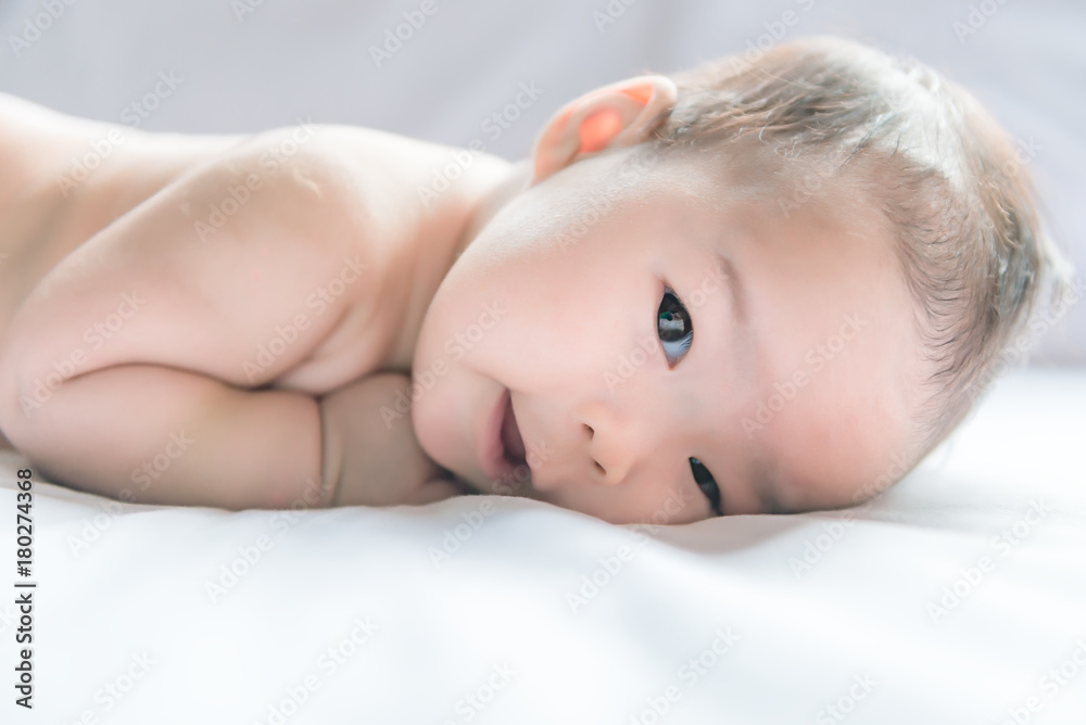 Cute asian baby lying on the bed from front angle Cute asian baby lying on the bed from front angle