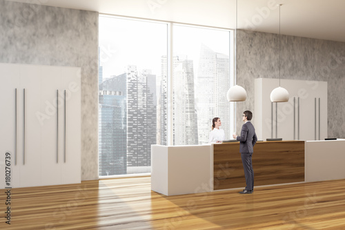 Wooden and concrete office, reception side people