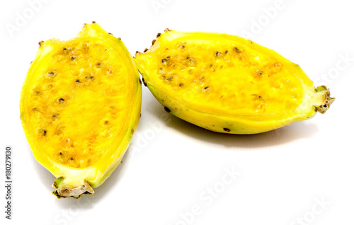 Two yellow green prickly pear halves with seeds isolated on white background.