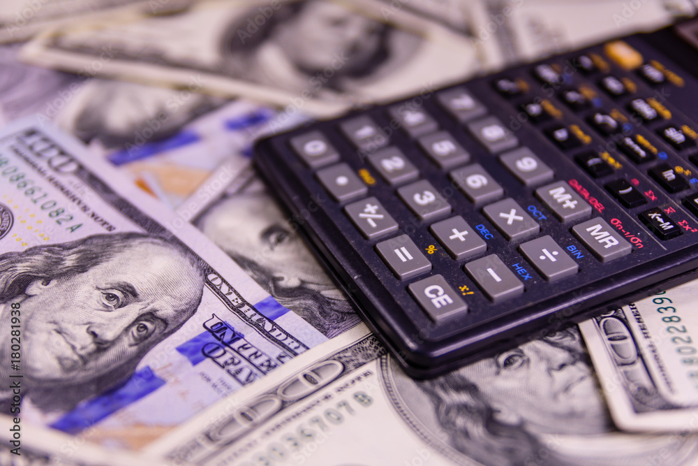 Modern calculator on a one hundred dollar bills Modern calculator on a one hundred dollar bills