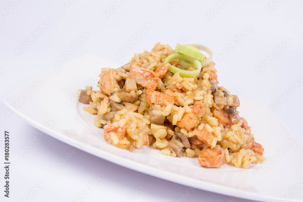 Risotto with mushrooms and chicken decorated with leek on a white background Risotto with mushrooms and chicken decorated with leek on a white background