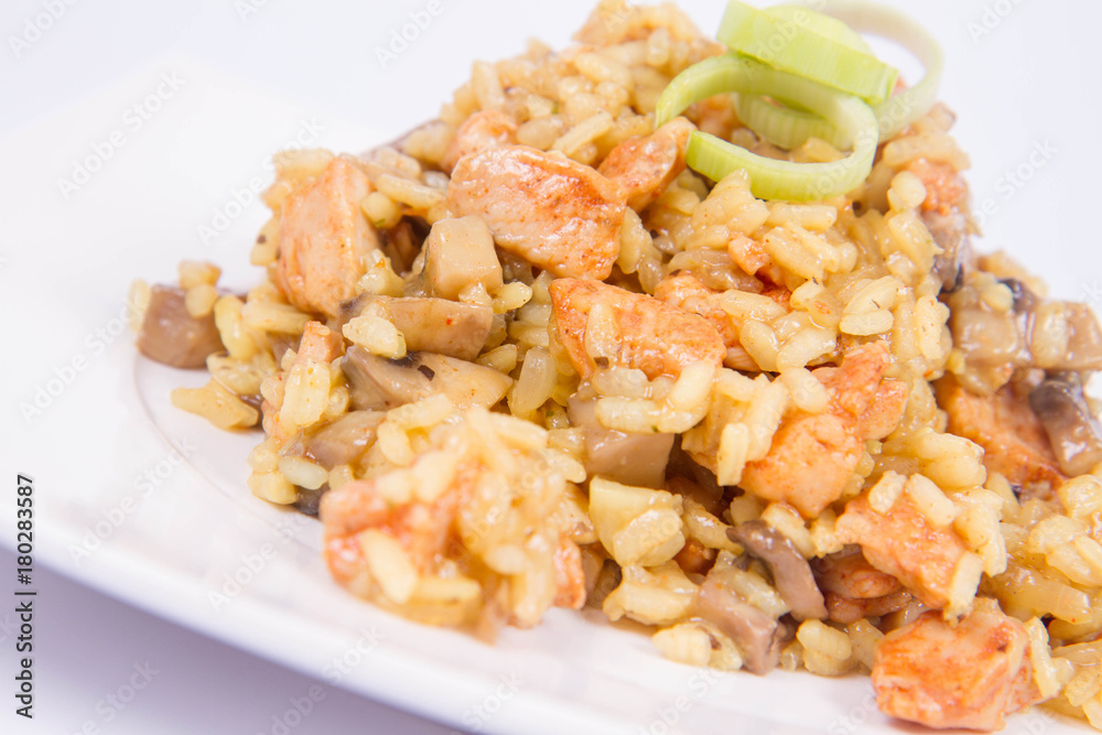 Risotto with mushrooms and chicken decorated with leek on a white background Risotto with mushrooms and chicken decorated with leek on a white background