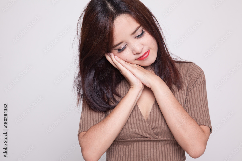 Beautiful young Asian woman with sleeping gesture. Beautiful young Asian woman with sleeping gesture.
