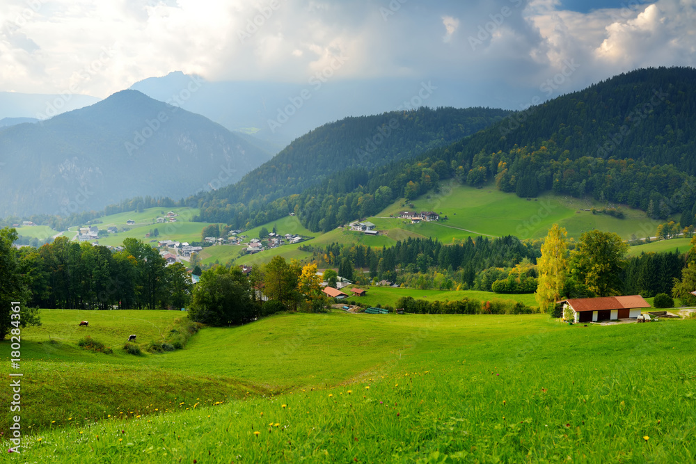 Breathtaking lansdcape of mountains, forests and small Bavarian villages in the distance. Scenic view of Bavarian Alps with majestic mountains in the background.