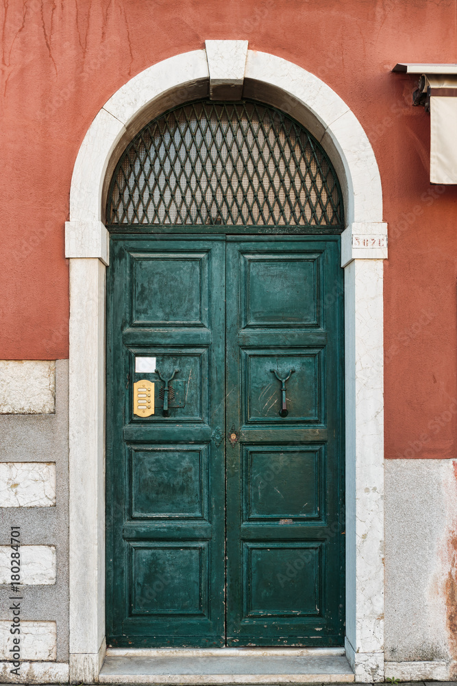 Old wooden door in a stone house Italian Old wooden door in a stone house Italian