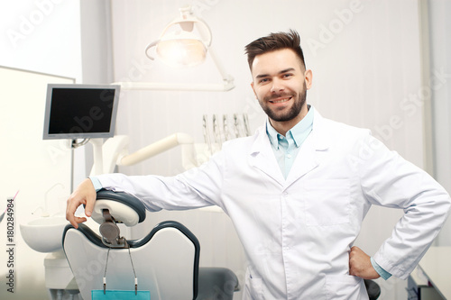 A yong cheerfull male dentist