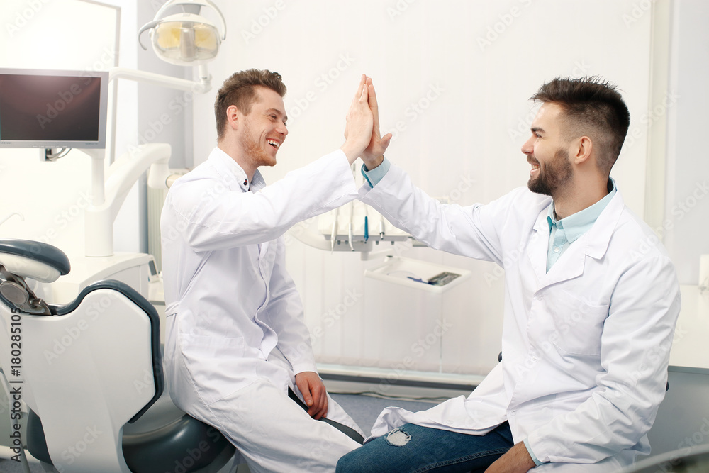 Fototapeta premium Two male dentists in clinic