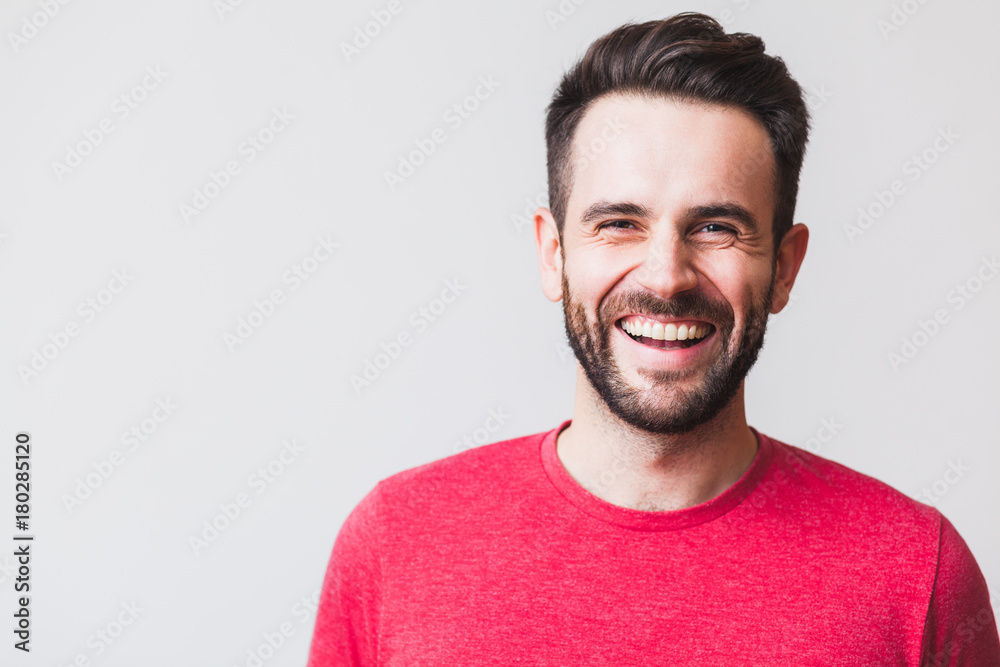 Portrait of a handsome young man laughing Portrait of a handsome young man laughing