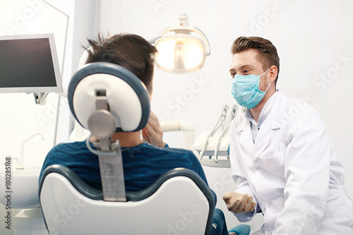 Portrait of a dentist listening to a patient