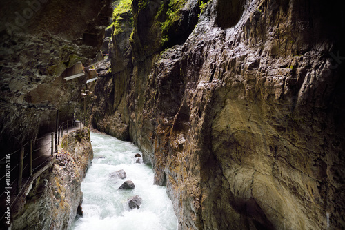 Blue water flowing in the Partnach Gorge or Partnachklamm, incised by a mountain stream in the Reintal valley near the town of Garmisch-Partenkirchen. photo