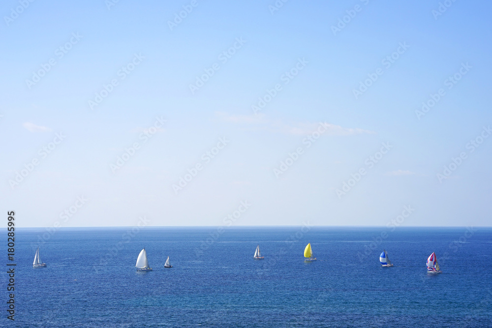 Yacht on the sea horizon on a summer day