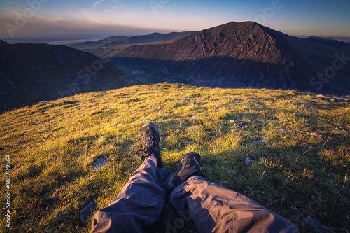 POV Hiker Laying on Mountain Top at Sunset