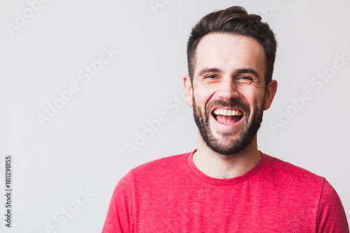 Portrait of a handsome young man laughing