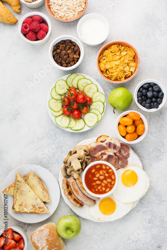 Full English breakfast  eggs  bacon  sausages  breads and fruits