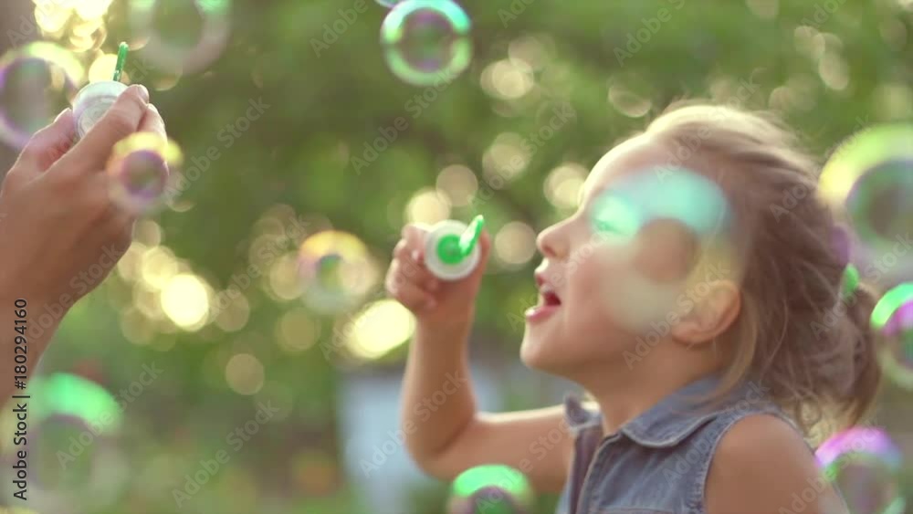 Beautiful mother and her little daughter having fun in summer park together. Slow motion 4K UHD video 3840X2160 Beautiful mother and her little daughter having fun in summer park together. Slow motion 4K UHD video 3840X2160