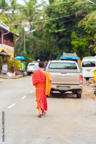 Monks on a city street in Louangphabang, Laos. Copy space for text. Vertical.