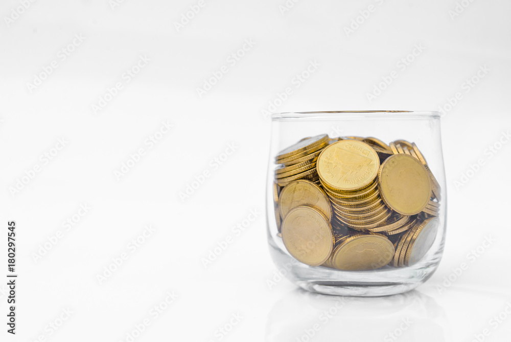 Many gold coins in glass on white background Many gold coins in glass on white background