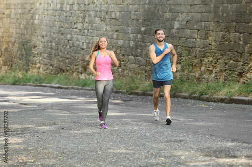Young man and woman running...