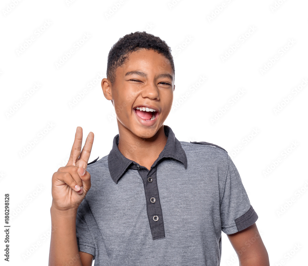 African-American teenager showing peace sign on white background African-American teenager showing peace sign on white background