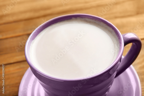 Cup with yummy cocoa on wooden table  closeup