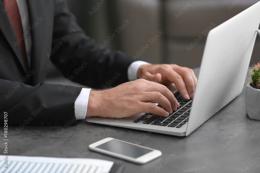 Businessman using his laptop while working in office Businessman using his laptop while working in office