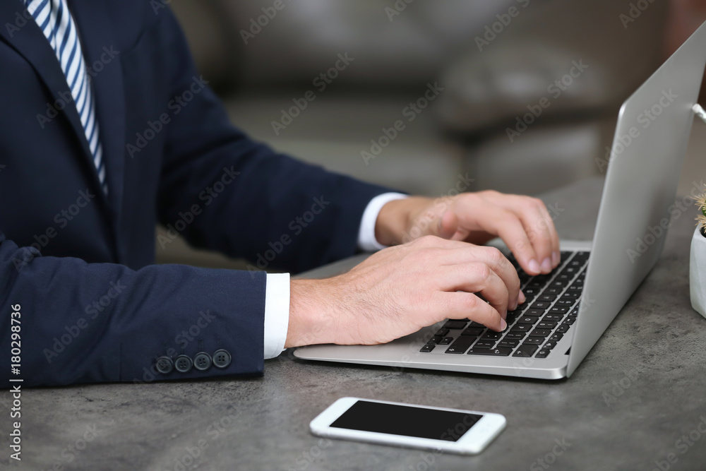 Businessman using his laptop while working in office Businessman using his laptop while working in office