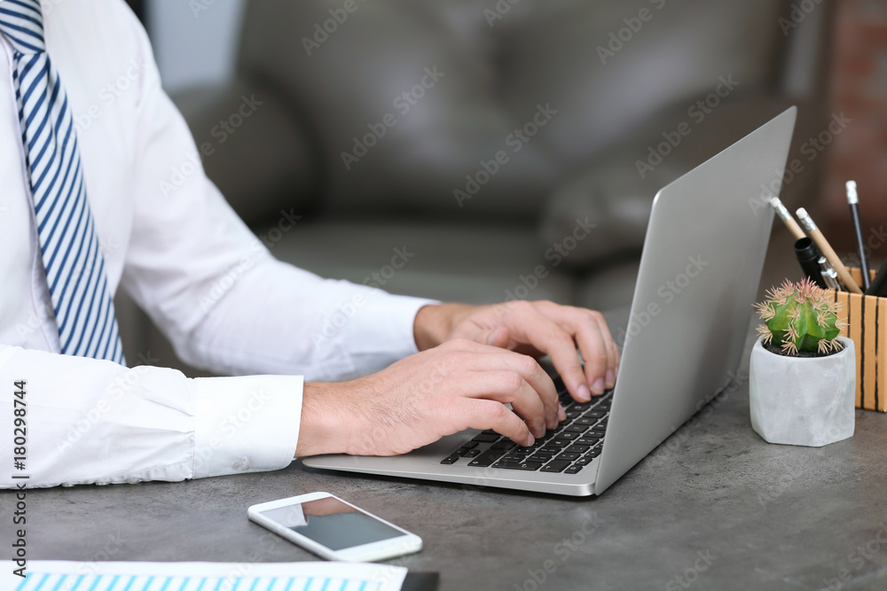 Businessman using his laptop while working in office Businessman using his laptop while working in office