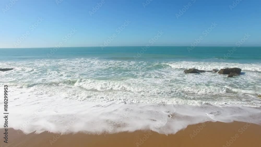 Aerial view of surfers in an amazing and unspoiled beach Aerial view of surfers in an amazing and unspoiled beach