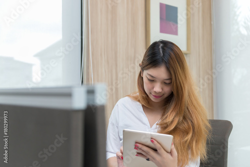 Thai girl work on the desk businesswoman in white dress