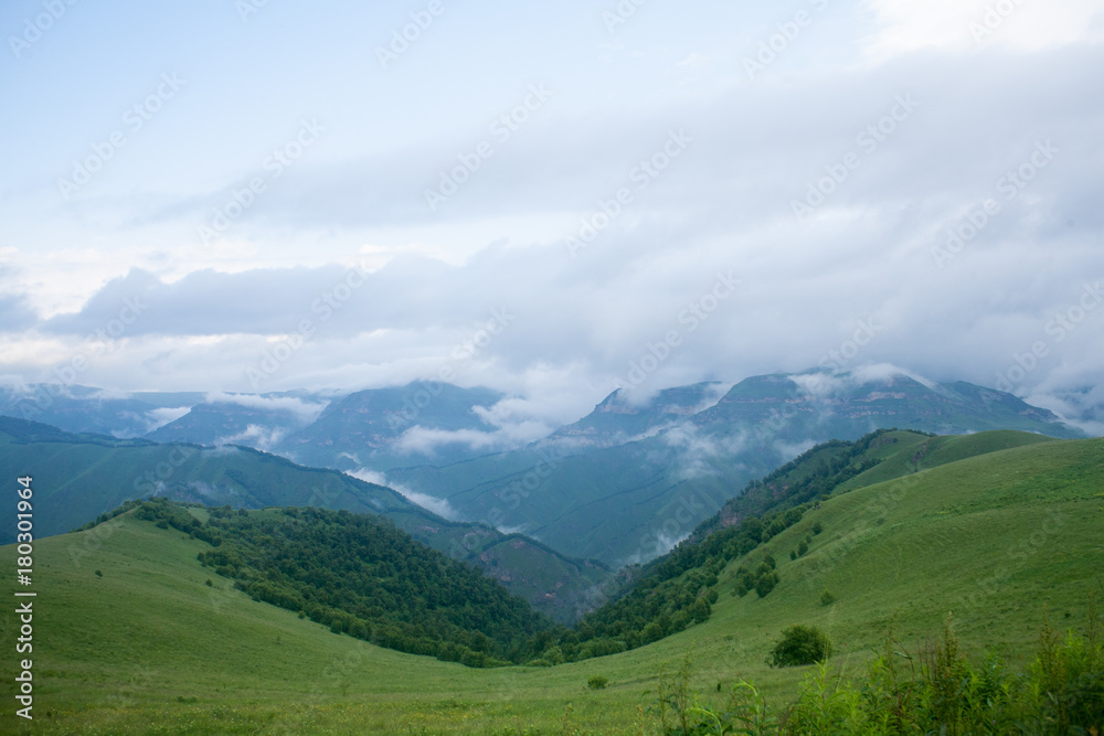 Landscape high mountains in dense fog tops of mountains in clouds North Caucasus Elbrus