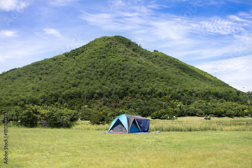 Travelers people build tent camping on grass field for rest and sleep near mountain at Chang Hua Man Royal Initiative and Agricultural Project