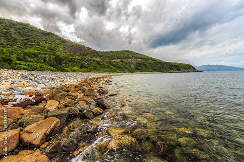 KHANH HOA, VIETNAM - AUG 02, 2014 - Beautiful sea with mountains in Nha Trang, Vietnam. Nha Trang is a coastal city and capital of Khanh Hoa, on the South Central Coast of Vietnam.