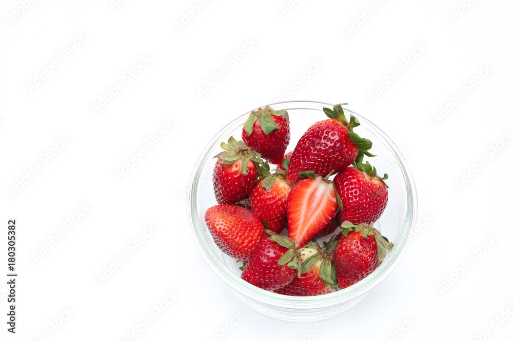 The many strawberries in glass cup on white background , isolated The many strawberries in glass cup on white background , isolated