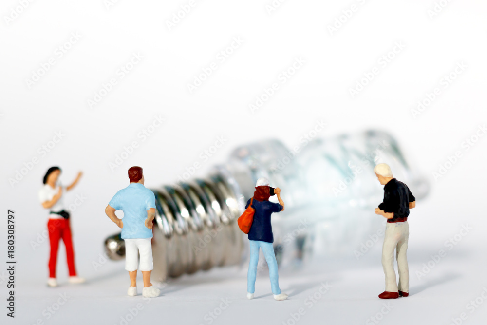 miniature people: photographer take a picture of light bulb. idea business concept miniature people: photographer take a picture of light bulb. idea business concept