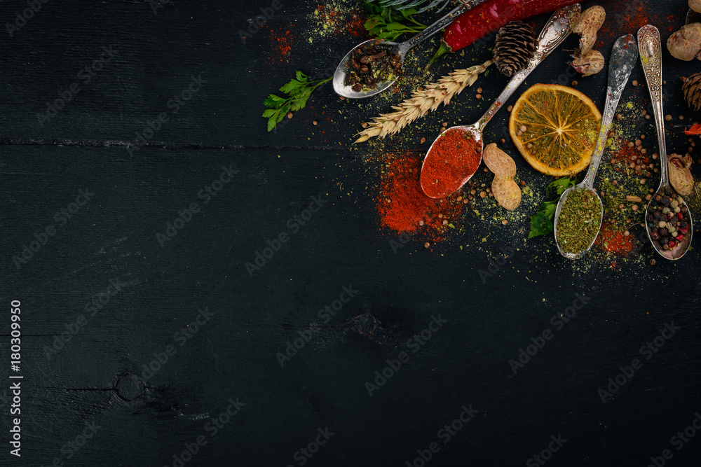 Spices and herbs. A large assortment of spices. Indian cuisine. On the wooden table. Top view. Free space for text. Spices and herbs. A large assortment of spices. Indian cuisine. On the wooden table. Top view. Free space for text.