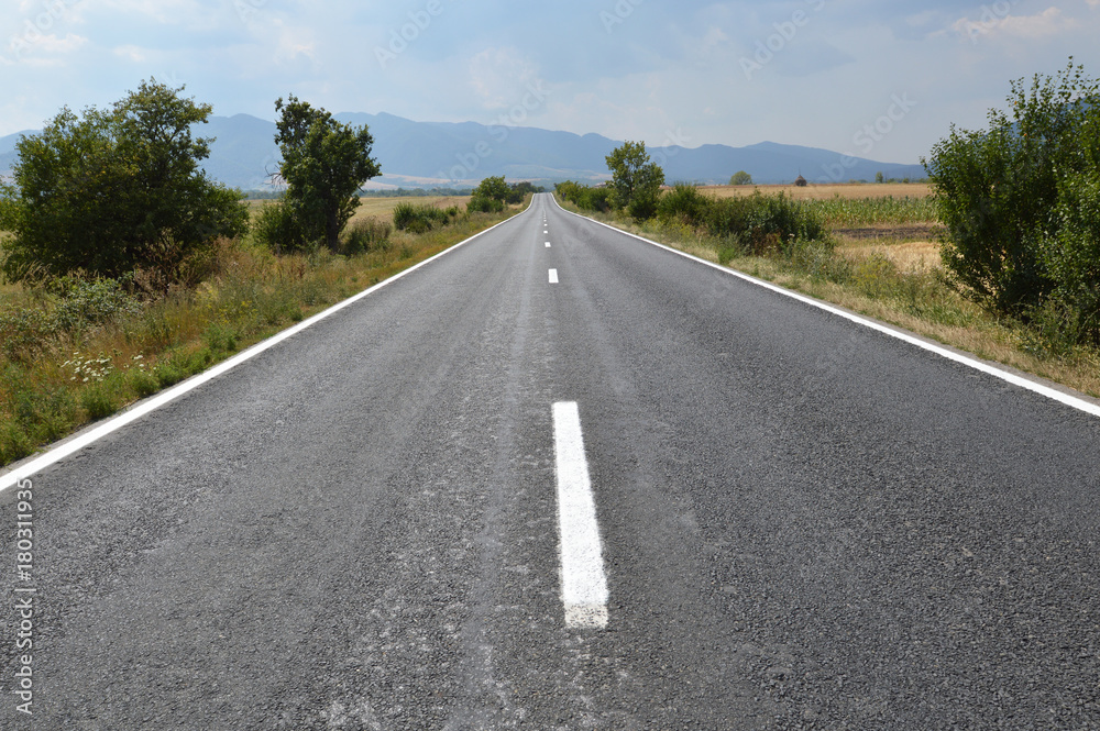 Panoramic view of empty road with mountains on the background