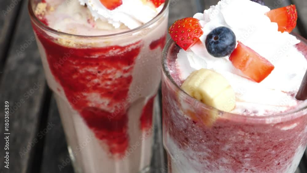 Fresh Vegan Strawberry And Raspberry Milkshake With Whipped Cream. Closeup. 4K. Fresh Vegan Strawberry And Raspberry Milkshake With Whipped Cream. Closeup. 4K.