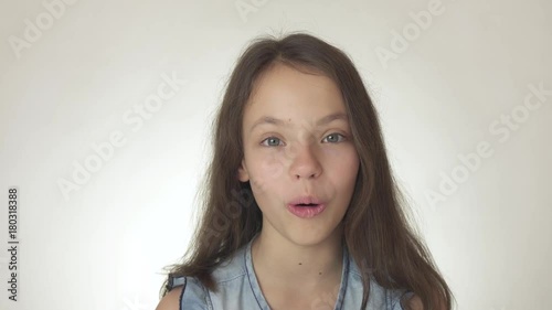 Beautiful happy teenage girl looks and is surprised close-up on white background stock footage video