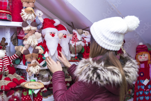 a young girl is buying Christmas decorations