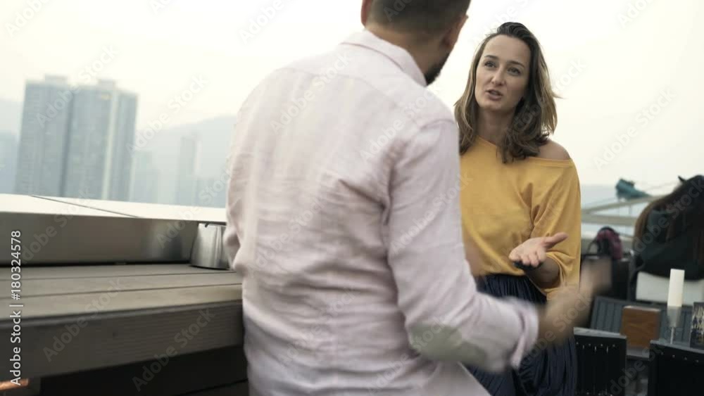 Young couple fighting sitting on terrace in bar
Young couple fighting sitting on terrace in bar