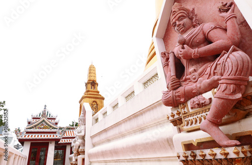 Statue and Ancient golden pagoda in Thailand temple photo