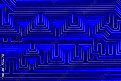 Conductive tracks on the motherboard of Printed Circuit Board close macro photo