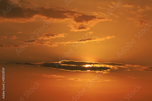 Orange sunlight behind the black cloud