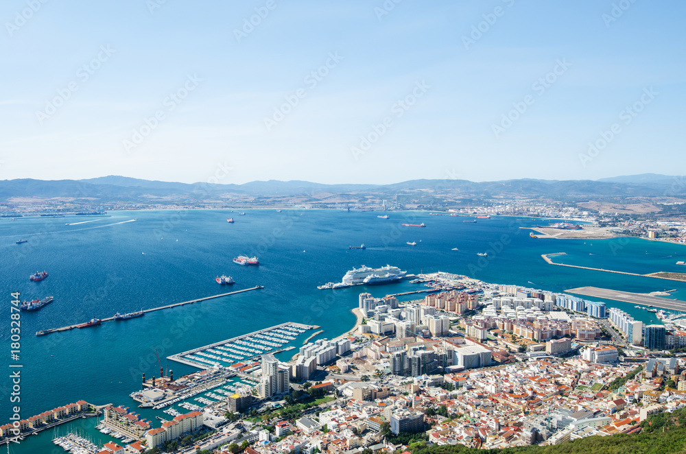 Overall view from top of the Rock of Gibraltar city, cruise port and marina, airport runway, Gibraltar Bay or Bay of Algeciras. 