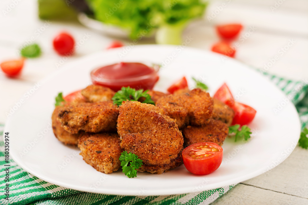 Chicken nuggets and sauce in plate on a white wooden background Chicken nuggets and sauce in plate on a white wooden background