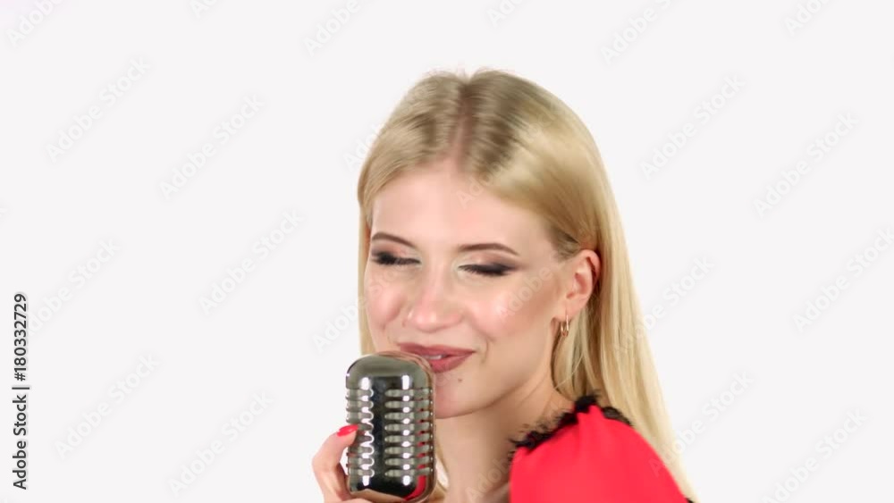 Girl dances and sings in a retro microphone. White background. Close up Girl dances and sings in a retro microphone. White background. Close up