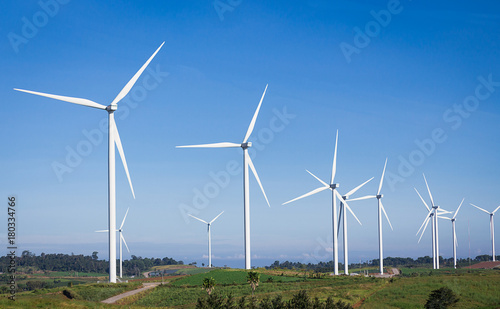 Turbines are rotating to produce electricity, photos with skies, mountains and trees are components.