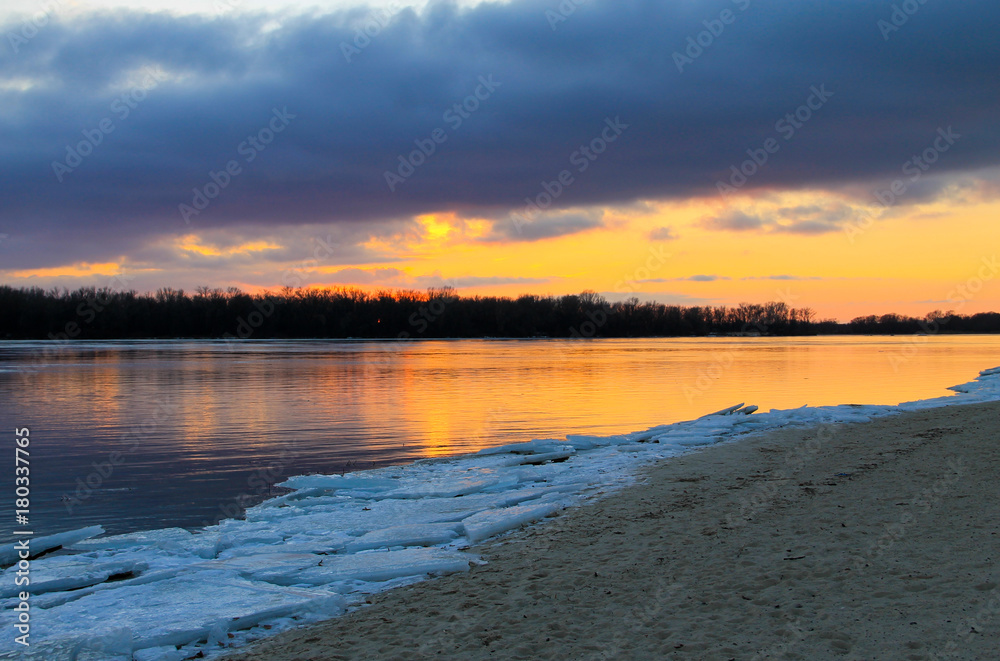 Bright sunset over a river Dnieper on winter